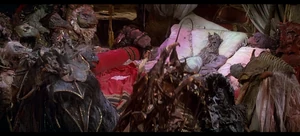 Emperor SkekSo crumbling away as the other Skeksis watched being so.