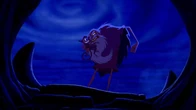 Jafar about to throw Abu back down into the cave in anger.