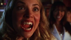 Buffy shows her vampire fangs.
