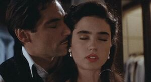 Timothy Dalton and Jennifer Connolly as Neville Sinclair and Jenny Blake