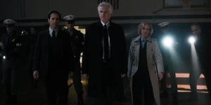 Brenner and his agents arriving at Hawkins Middle School.
