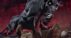 Kazar pins Samson to the ground.