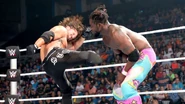 AJ Styles kicking Kofi Kingston.