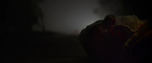 The Man in the Mask lying on the ground, presumably dead from his injuries.
