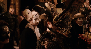 The Vampire people stand masked as the ballroom entrance opens.