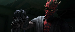 Maul holds Savage's new mechanical hand.