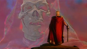 Skeletor (in a hologram) pledges his takeover of Eternia as He-Man watches from the distance.