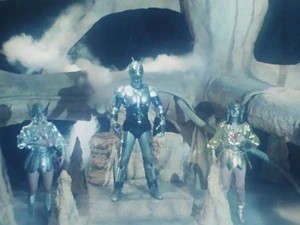 Kara and Mara standing on either side of Shadow Moon.
