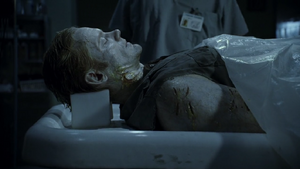 Ray's possessed corpse being examined.