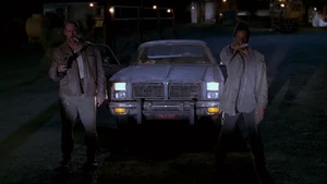 Rig and Charlie holding T. Paul and Nick at gunpoint