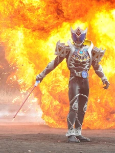 The Fangire explodes behind Saga.