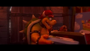 Bowser searches through his various paintings.