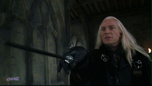 Lucius brandishing his wand