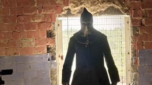 Cam as The Executioner appears in front of Allison.