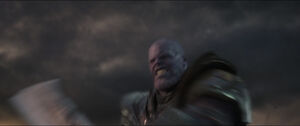 Thanos savagely swinging his sword at Captain America's shield.