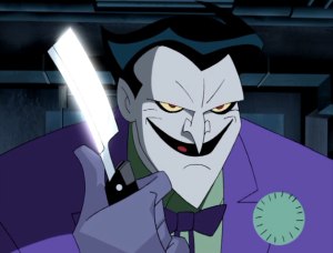 The Joker carrying a knife, planning to torture a captive Batman.