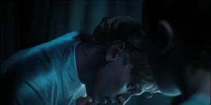 One showing his neck to reveal where the Soteria chip is implanted that is suppressing his powers.