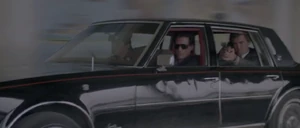 Keller driving while Brenner and another killer shoot