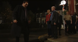 Phil watches as Steve, bloodied and defeated from their fight in The Queen Vic, leaves the pub in disgrace (2000).