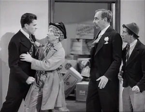 Grover nearly attacked by a retaliating Tommy being restrained by Wacky