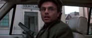 Francis getting in a car as he loads his gun.