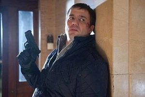 Warren Fox armed with a handgun.