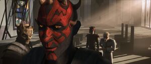 Almec informs Maul of news causing him to grin.