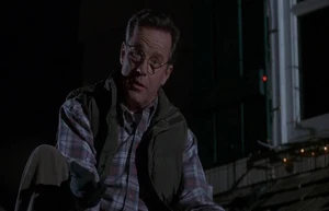 Ted putting up Christmas lights on Howard's roof.