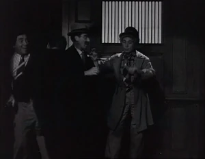 Grover against Flywheel, Ravelli, and Wacky in the darkened elevator