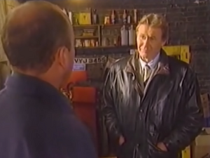 Phil Mitchell confronting Peggy's boyfriend George Palmer over his illicit activities.