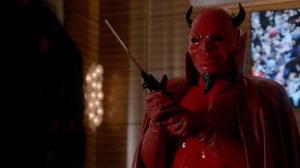 The Red Devil using an electric carving knife to decapitate Gigi.