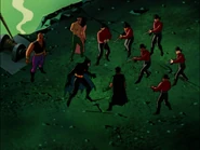 Ubu and his men holding Batman and Robin at gunpoint