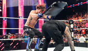 AJ-Styles-Hits-Roman-Reigns-with-a-Chair