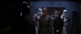 Commander Igar brings Luke Skywalker before Vader.