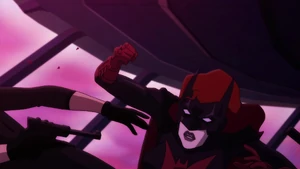 Talia gets punched in the face by Batwoman.