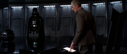 Tarkin and Vader in the conference room are alerted that the Death Star arrived at Yavin 4 and will orbit the planet.