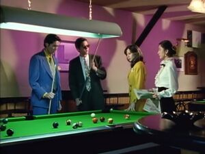 Riga meeting with his fellow executives over a pool table.