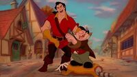 Gaston and LeFou laughing when one of Maurice's inventions backfired.