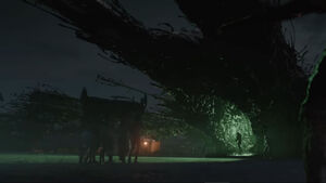 A group of humans, enslaved by the Klum, carrying materials into a ship.
