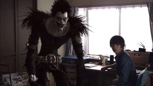 Light Yagami in the Death Note live-action series along with Ryuk.