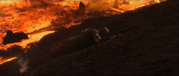 Vader claws his way back up the bank with his still-intact mechanical arm, struggling against his extreme injuries.