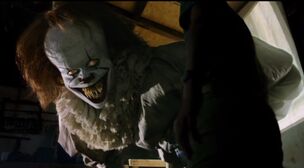 Pennywise's Evil Smile and Crazy Sharp Teeth as it emerges from the projector screen.