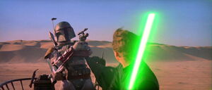 Luke Skywalker cuts Boba's blaster in half.