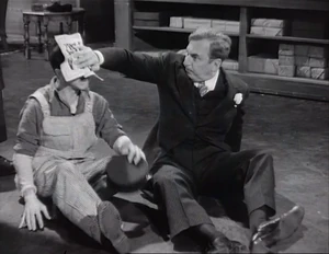 Grover sticking the label on the janitor's head in return