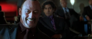 Petrovich watching Cross nearly being killed during the next Rollerball match