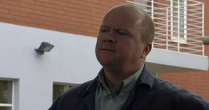 Phil learns that Dan grassed him up to the police about his motor scam and plans to get payback on the latter (2000).