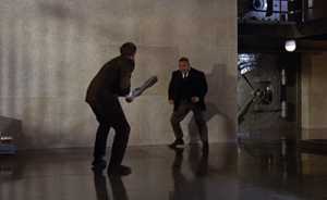 Oddjob fights James Bond.