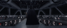 Darth Vader walks on the bridge of a gray-hulled Venator-class Star Destroyer.