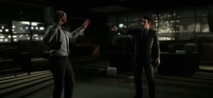 Victor holding Max at gunpoint in the UFE headquarters.