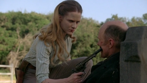 Dolores threatens William with her gun.